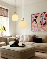 Stockholm Pendel Ø24 Marmorbrun fra Halo Design i en stue ved en sofa - blødt lys og ro ved sofaen